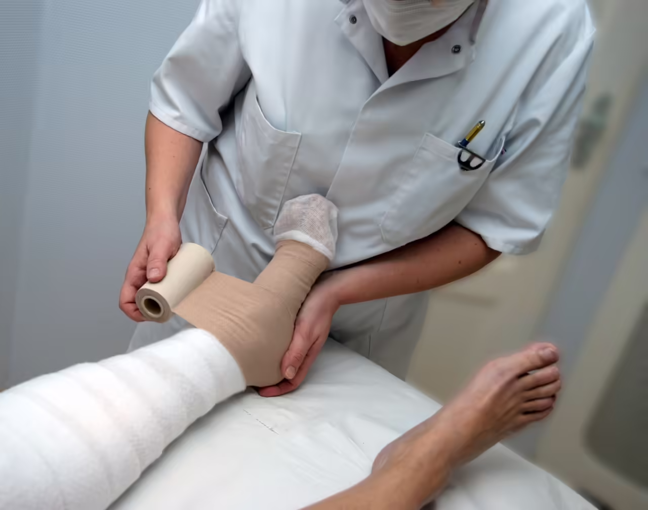 nurse putting bandage on woman legs in hospital 2026 03 24 07 09 35 utc