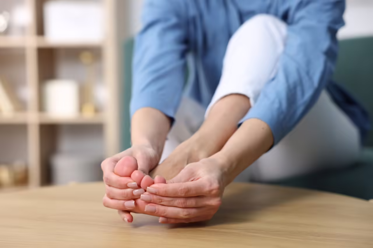 woman massaging her aching foot while sitting at h 2026 05 11 16 45 37 utc